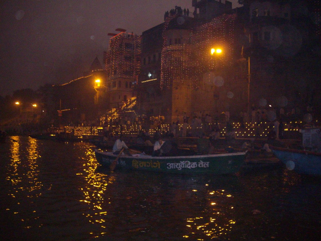 Boats on the Ganga beside ghats lit with thousands of lamps during Dev Deepawali, Varanasi