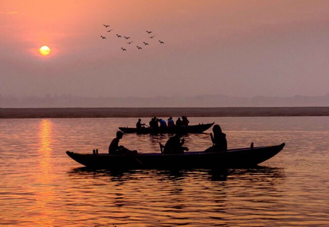 Traditional boats on the Ganges at sunrise in Varanasi