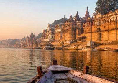 Sunrise over the Ganga and historic ghats viewed from a wooden boat in Varanasi